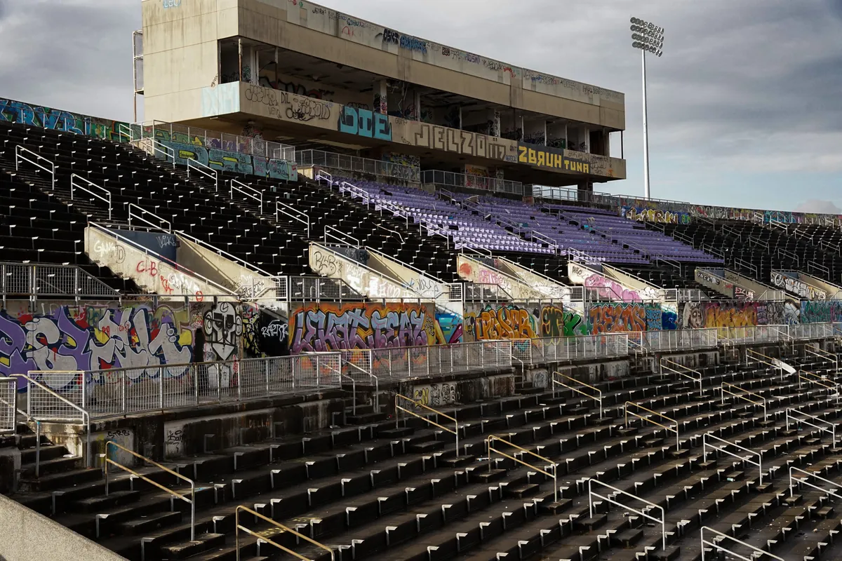 Graffiti-covered bleachers of an abandoned stadium