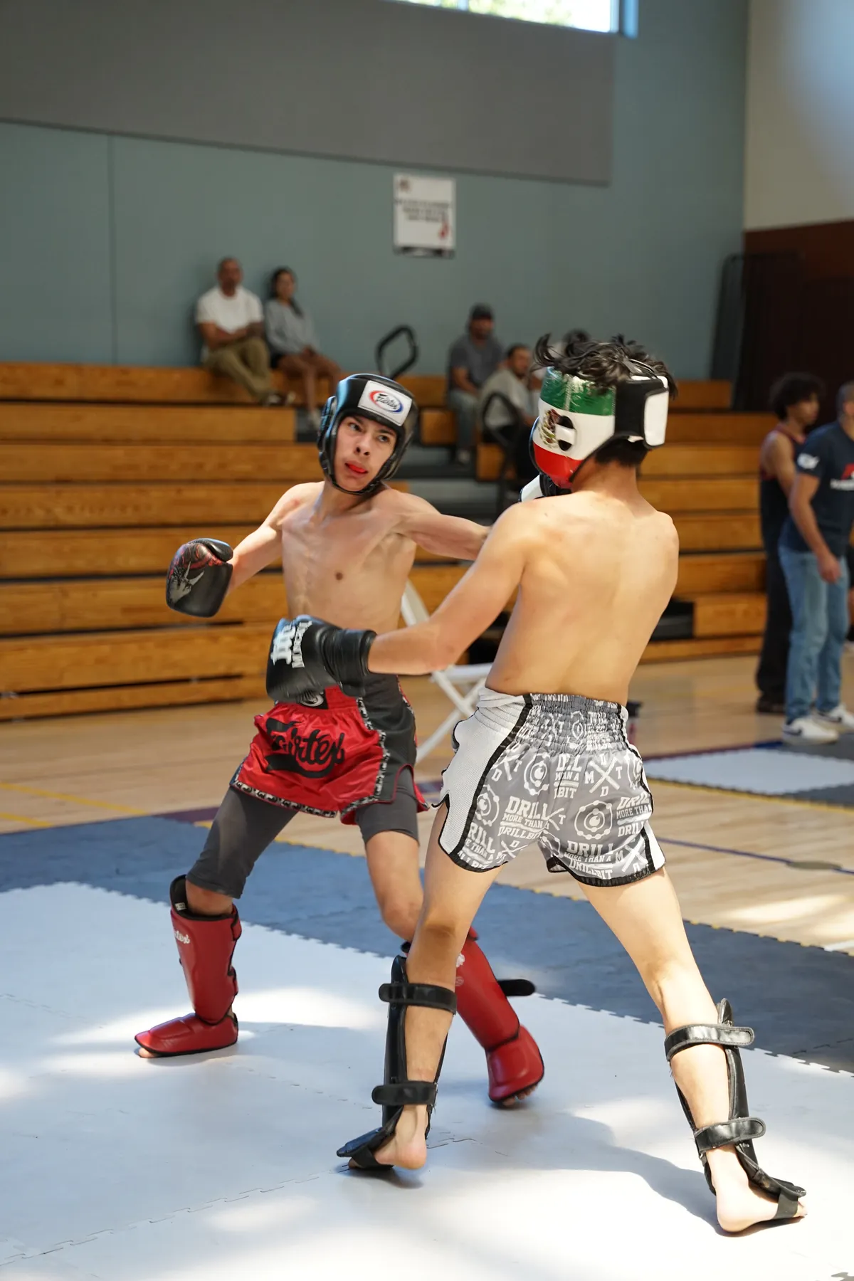 Two kickboxers sparring in a gym