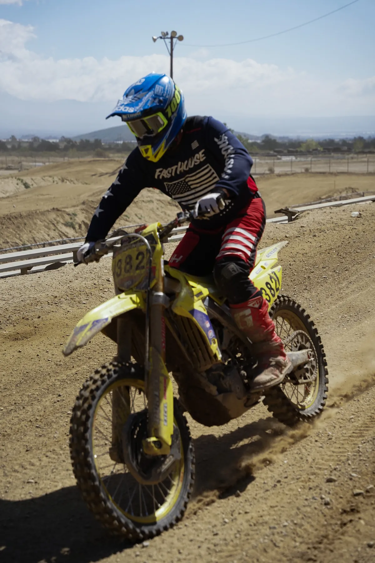 Motocross rider cornering on a dirt track