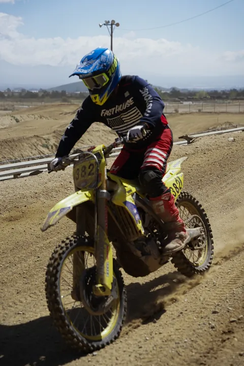 Motocross rider cornering on a dirt track