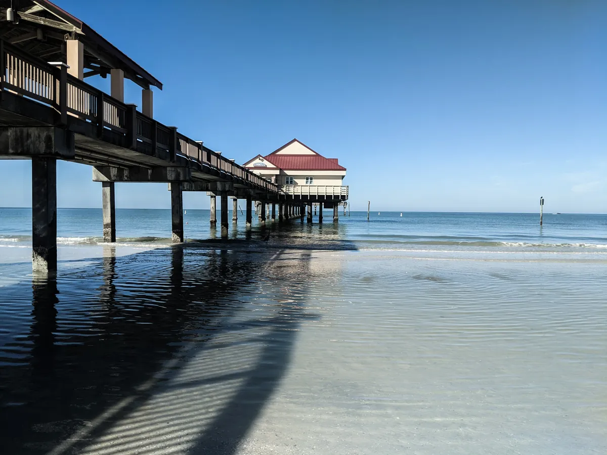 Wooden pier stretching over calm turquoise water